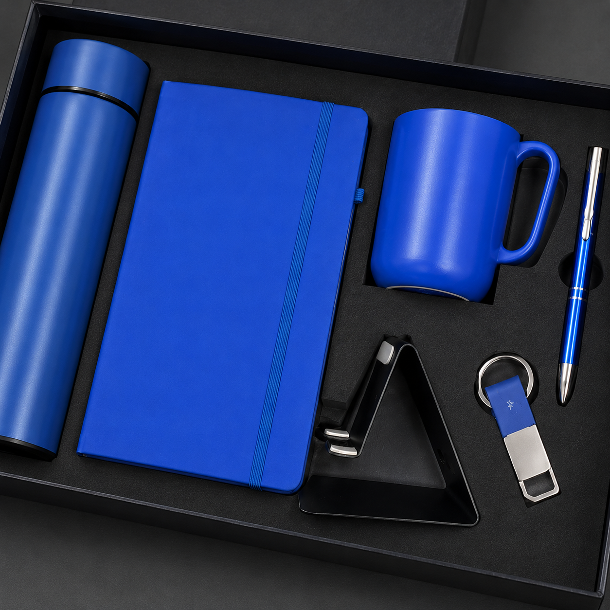 6 IN 1 BLUE  A5 NOTEBOOK, TEMPERATURE BOTTLE, STEEL MUG, MOBILE STAND, PEN, & KEYCHAIN image 2
